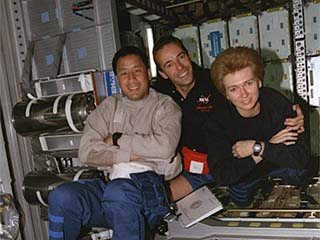 Ed Lu, Jean-Francois Clervoy, and Elena Kondakova pose for the camera in the Spacehab module. 